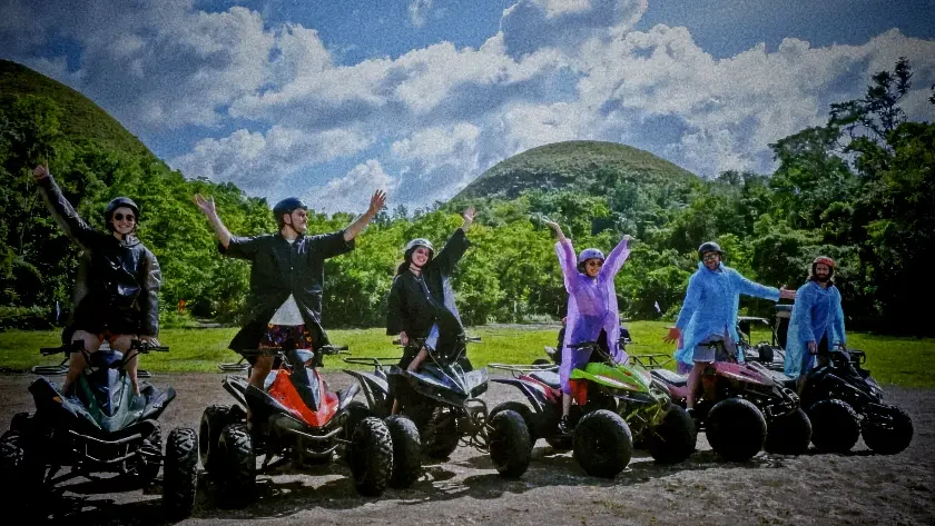 125638 bohol countryside adventure tour Group on their ATV vehicles in front of Chocolate Hills