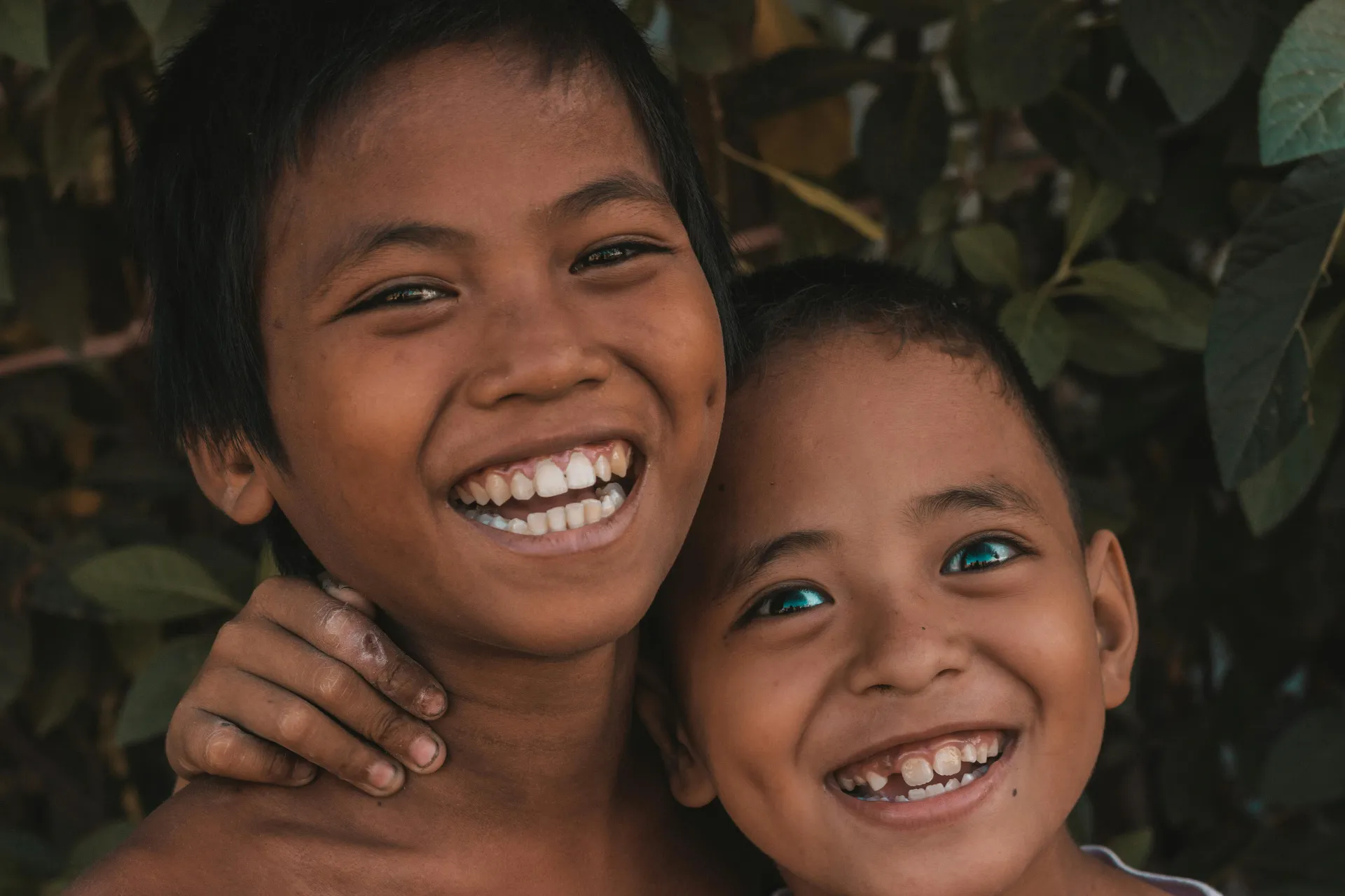 bohol philippines Close up portrait of two happy boys smiling with greenery background in Cebu