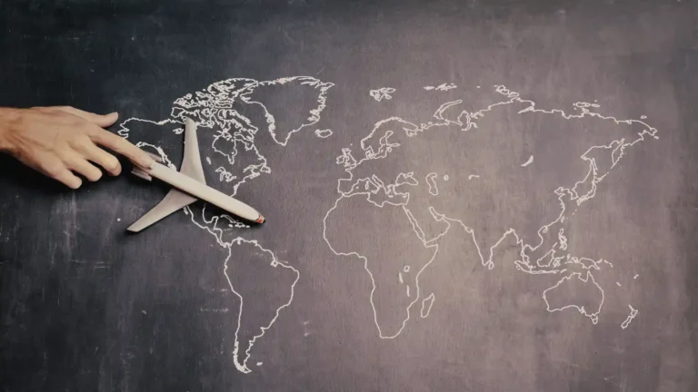 stock-person-driving-toy-airplane-on-world-map